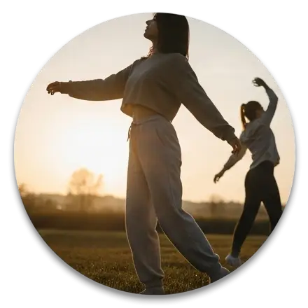 Women stretching outdoors at sunrise, dressed in activewear, embracing movement and mindfulness — Move Your Body theme.