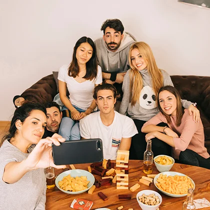 A group of friends sitting together at a table, exchanging thoughts and encouragement, creating a transformative atmosphere.