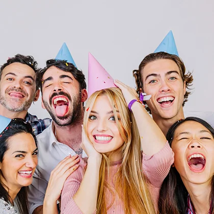 A joyful group of friends wearing colorful party hats, celebrating together and embodying the spirit of friendship.