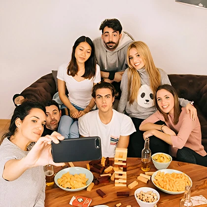 A group of friends sitting together at a table, exchanging thoughts and encouragement, creating a transformative atmosphere.