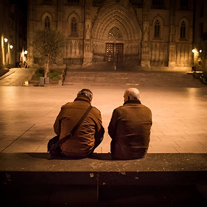 Two friends on a bench, illustrating the importance of support and companionship in fostering growth and progress.
