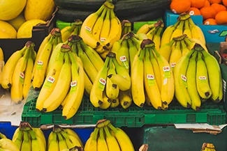 A cluster of ripe bananas arranged together, showcasing their vibrant yellow color and smooth texture.