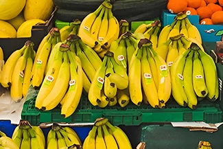 A cluster of ripe bananas arranged together, showcasing their vibrant yellow color and smooth texture.