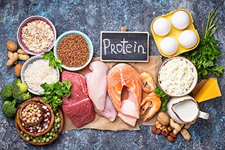 A blue background featuring various protein-rich foods, including chicken, beans, and tofu, essential for muscle building.