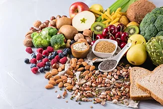 A diverse selection of fruits and vegetables artfully arranged on a table, highlighting fiber's role in promoting satiety.