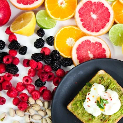 A colorful plate of fruit, avocado, and eggs, providing a wholesome breakfast to boost your morning energy.