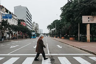 A man navigating a city street in the morning, illustrating how a simple walk can positively influence one's day.