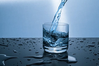 A pristine glass of water, illustrating the vital benefits of drinking water for maintaining good health.