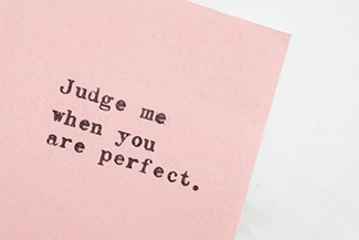 A thought-provoking image featuring the phrase 'Judge me when you are perfect,' encouraging self-reflection and humility.