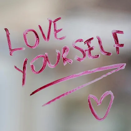 A heart symbol with the phrase 'Love Yourself' promoting the message of self-love and positivity.