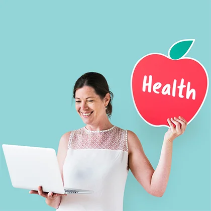 A woman holds an apple adorned with a health symbol, symbolizing the importance of healthy choices for a fulfilling life.