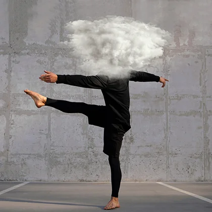 A man kicks upward with a cloud above, illustrating the harmony of physical movement and a clear, focused mind.