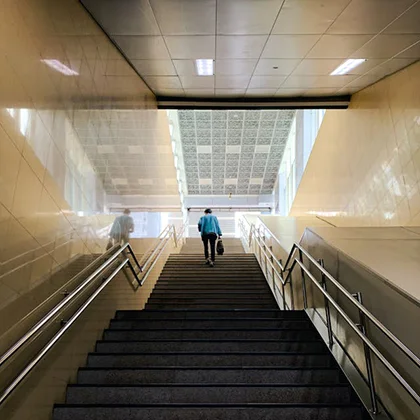 A person walks up the stairs, encouraging a more active approach to daily life and wellness.