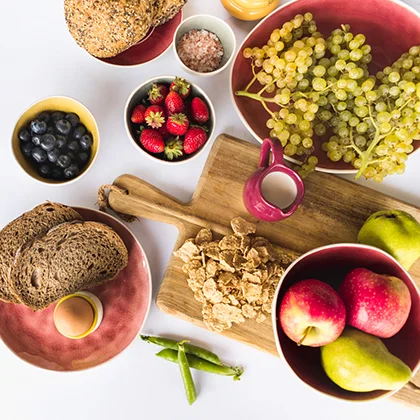 A table laden with various foods such as bread, fruit, and eggs, highlighting the importance of wise food choices for well-being.