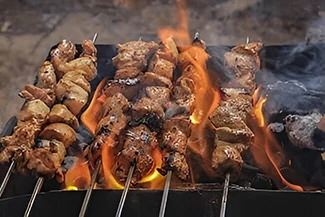 Juicy grilled chicken kebabs on the grill, exemplifying a healthier cooking technique compared to traditional frying methods.
