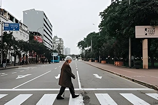 A man navigating a city street in the morning, illustrating how a simple walk can positively influence one's day.