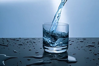 A pristine glass of water, illustrating the vital benefits of drinking water for maintaining good health.