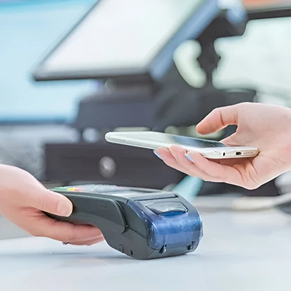 A person with a phone and debit machine, representing the idea that investing in health is essential for well-being.
