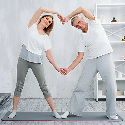 A senior couple performing yoga in a tranquil space, embodying gratitude for their physical abilities and wellness.