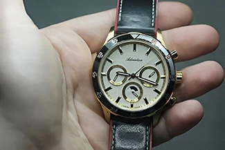 A person holds a watch in their hand, symbolizing the importance of time and the value of slow but steady progress.