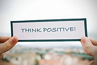 An inspiring scene featuring the message 'think positive!', promoting positivity in difficult moments.