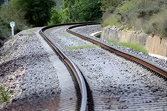 A train track stretches into the distance, symbolizing the endless potential of journeys yet to be taken.