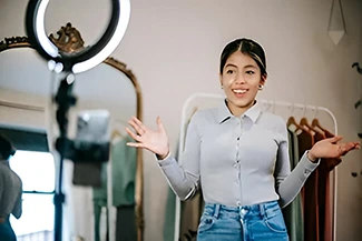 A woman stands before a mirror, hands outstretched, embodying the message to choose happiness today.