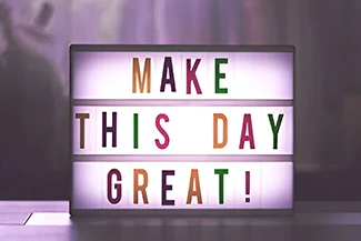 An inspiring image featuring the message 'Make this day great' alongside a call to believe in yourself and persevere.