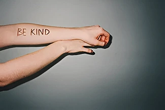 An uplifting visual featuring the message 'Be kind,' promoting self-love and positivity.