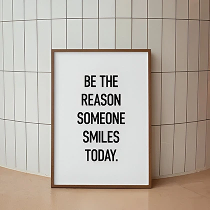 A warm and uplifting message encouraging kindness: 'Be the reason someone smiles today' in a cheerful design.