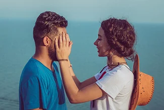 A man and woman gaze into each other's eyes, sharing a moment of connection and understanding.