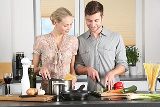 A man and woman prepare a meal in the kitchen, highlighting the importance of teamwork and partnership in everyday life.