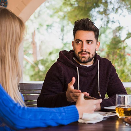 A man seated at a table, engaged in thoughtful contemplation, embodying the spirit of compromise and collaboration.