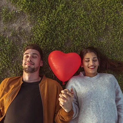 A man and woman lying on the ground, symbolizing connection and the importance of nurturing their relationship.