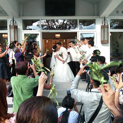 A wedding party gathers as a photographer captures joyful moments, honoring the love and respect among family and friends.