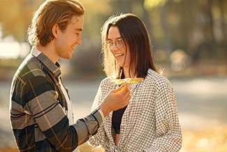 A man and woman are positioned in a vibrant fall scene, embodying the themes of honoring commitments and keeping promises.