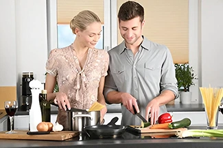 A man and woman prepare a meal in the kitchen, highlighting the importance of teamwork and partnership in everyday life.