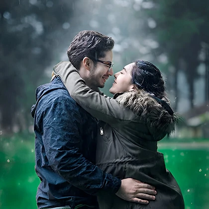A couple embraces in the rain, symbolizing love and growth through shared experiences and mutual learning.