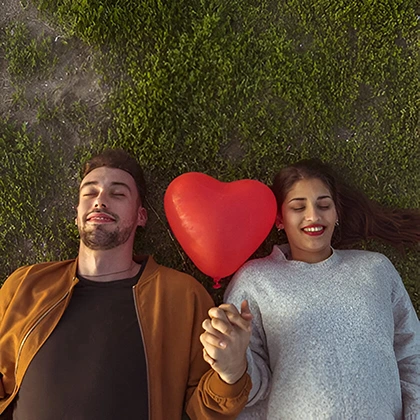 A man and woman lying on the ground, symbolizing connection and the importance of nurturing their relationship.