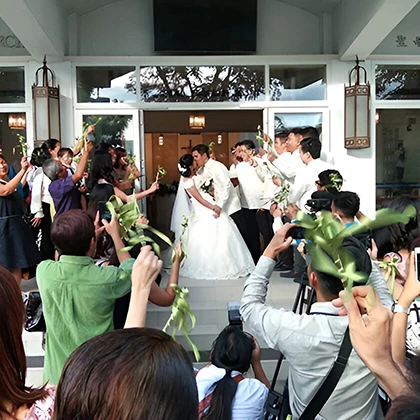 A wedding party gathers as a photographer captures joyful moments, honoring the love and respect among family and friends.
