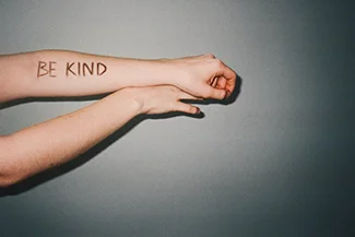 An uplifting visual featuring the message 'Be kind,' promoting self-love and positivity.