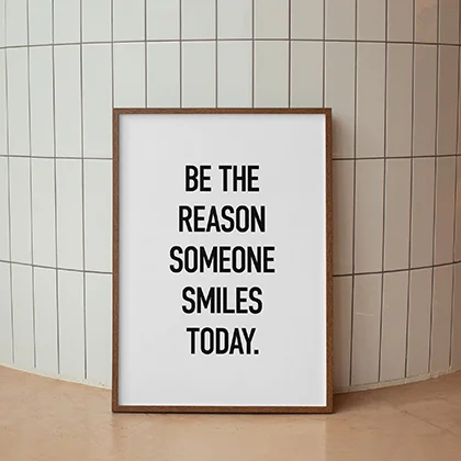 A warm and uplifting message encouraging kindness: 'Be the reason someone smiles today' in a cheerful design.