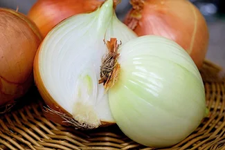 Fresh onions arranged artistically, illustrating their nutritional value, especially as a source of vitamin C.