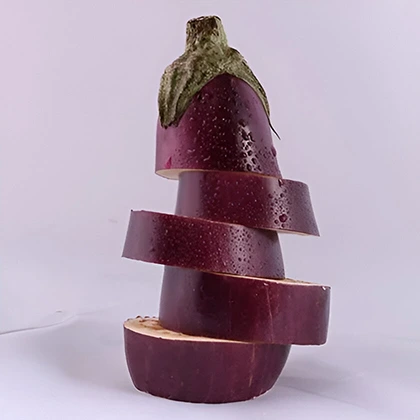 A stack of vibrant eggplant slices positioned on a white background, highlighting their smooth texture and deep purple hue.