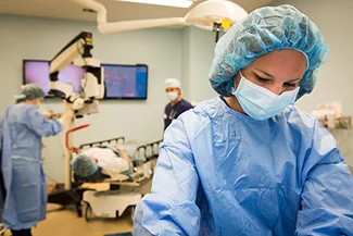 A woman in a surgical gown, symbolizing the vital role of women in the healthcare industry.