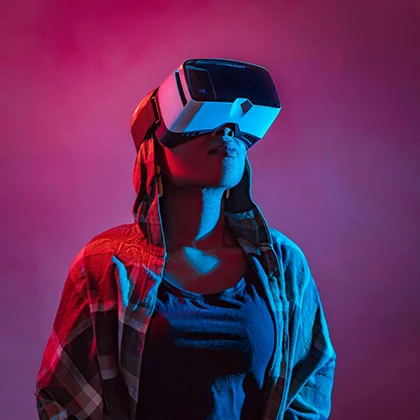 A woman wearing a virtual reality headset, symbolizing women's vital role in innovation and technology development.